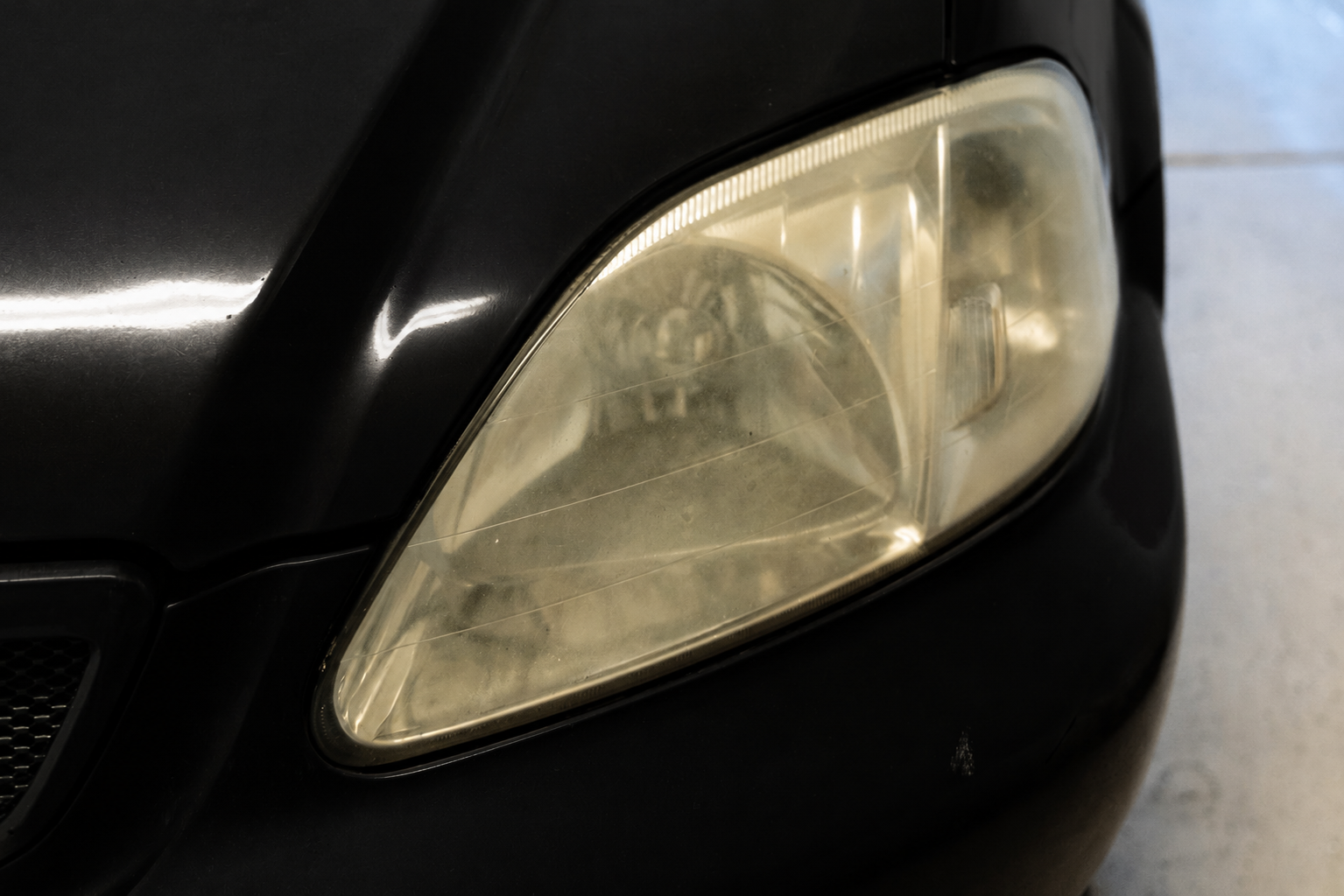 Severely oxidized headlight before restoration